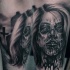 Antic horror movie themed terrifying forearm tattoo of bloody zombie woman in cemetery