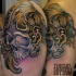Antic like colored shoulder tattoo of natural looking skull