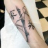 Asian oriental style bamboo tree branch and hieroglyphs forearm length tattoo in black ink