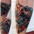 Asian oriental style colored carp fish in water waves designed tattoo on leg
