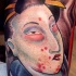 Asian style designed and colored biceps tattoo of bloody geisha portrait