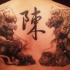 Asian traditional detailed upper back tattoo of lion statues with symbol