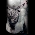 Awesome black ink side tattoo of dark tree with crows
