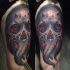 Awesome colored thigh tattoo of demonic skull with flames