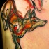 Tatuaje en el hombro, zorro de colores rojo y naranja