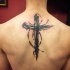 Hermoso tatuaje con cruz negra en la espalda