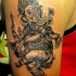 Tatuaggio sul braccio il dio Ganesha che balla