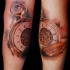 Beautiful looking colored arm tattoo of antic golden clock