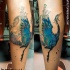 Beautiful looking colored leg tattoo of beautiful bird