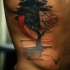 Beautiful looking colored side tattoo of dark tree