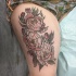 Beautiful looking colored thigh tattoo of big beautiful flowers