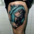 Beautiful looking colored thigh tattoo of seductive woman with flower