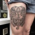 Beautiful painted black ink thigh tattoo of elephants stylized with ornaments