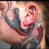 Snake tattoo on neck and face