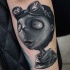 Big black and white cartoon style arm tattoo of funny hero