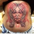 Big colored belly tattoo of demonic woman face with goat skull
