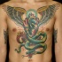 grande serpente verde con cuore e ali  tatuaggio