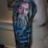 Big illustrative style colored shoulder tattoo of Gandalf wizard and towers