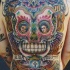 Tatuaggio colorato sulla schiena grande teschio in stile messicano