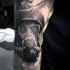 Black and gray style amazing looking detailed soldier in gas mask tattoo on arm