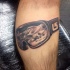 Black and gray style amazing looking leg tattoo of snowboarding glasses