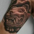 Black and gray style biceps tattoo of stone statue