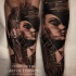 Black and gray style colored arm tattoo of woman portrait
