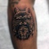 Black and gray style colored arm tattoo of raccoon with glasses and can