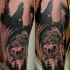 Black and gray style colored shoulder tattoo of wolves in forest