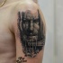 Black and gray style colored shoulder tattoo of old warrior with sword