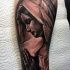 Black and gray style detailed arm tattoo of woman in hood