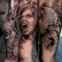 Black and gray style detailed arm tattoo of screaming woman with vine and dark tree