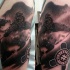 Black and gray style detailed shoulder tattoo of man with snowboard