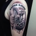 Black and gray style detailed shoulder tattoo of impressive symbol and lettering