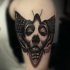 Black and gray style detailed shoulder tattoo of insect with woman face