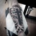 Black and gray style mystic cross in clouds tattoo on forearm