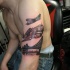 Black and gray style original looking shoulder tattoo of WW2 planes with bridge