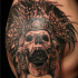 Black and gray style shoulder tattoo of ancient tribal skeleton with helmet