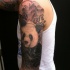 Black and gray style very detailed shoulder tattoo of panda bear in jungle