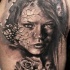 Black and gray style very detailed shoulder tattoo of woman with corrupted face and rose