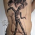 Black and gray style very detailed side tattoo of hand with wooden puppet