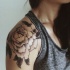 Black and white detailed massive peony flower tattoo on arm top