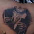 Black and white scapular tattoo of man and woman portrait
