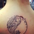 Black and white Yin Yang symbol back tattoo stylized with fish ornament