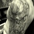Black biomechanical tattoo on shoulder