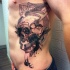Black ink abstract style side tattoo of demonic skull with deer horns