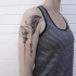 Black ink beautiful looking shoulder tattoo of beautiful flowers