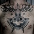 Black ink chest tattoo of ancient totem made from bird skulls