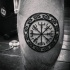 Black ink circle shaped leg tattoo of circle shaped symbol