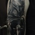 Black ink detailed looking shoulder tattoo of Bobba Fet